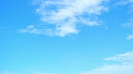 Wall Mural - a time lapse video captures the fluffy white clouds across a radiant blue sky. atmospheric circulati