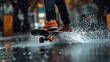 © hazia - Skateboarder splashing through a puddle on a rainy day.