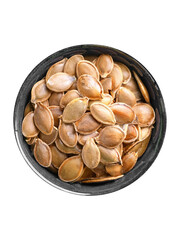 Wall Mural - A bowl of pumpkin seeds , illustrating the seeds' unique form and rich color. Isolated on background. 