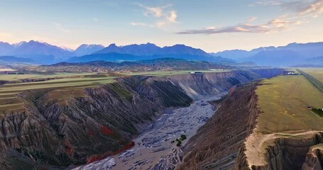 Canvas Print - Aerial view of spectacular canyon and river natural landscape at dusk. Beautiful Anjihai Grand Canyon geological scenery in Xinjiang, China.