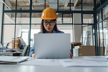 A Female Architect or Engineer Using a Laptop Computer in the Office Laptop Mockup