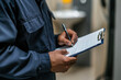 © Phichitpon - An auditor or inspector holds a clipboard and checklist of assessments and inspections .