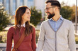© Dusan Petkovic - Portrait of happy couple holding hands and smiling at each other during walk on city street.