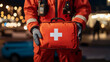 © VERTEX SPACE - Emergency responder holding red first aid kit with white cross, ready for action. background features blurred lights, creating sense of urgency and preparedness