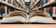 © Yan - An open book lies on a table, with a blurred library filled with books in the background. Concept Open Book on Table, Blurred Library Background, Reading Atmosphere, Knowledge & Learning