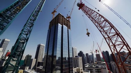 Aufkleber - Construction progress in urban skyscraper project with cranes and machinery in city