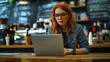 © Yauheniya - Young woman works on laptop in a cozy coffee shop surrounded by brewing equipment and a warm atmosphere. Generative AI