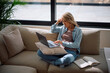 © Drazen - Thoughtful woman reading email on computer at home.