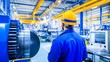 © Minom - A worker observes machinery in a modern industrial facility.
