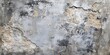 © Mehemmed - Abstract textured gray wall with aged plastered concrete showing smeared appearance and weathered patches in shades of gray and beige.