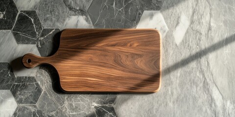 Wall Mural - Wooden cutting board on a contemporary hexagonal marble countertop top view with dark and light marble tones shadow play and natural wood grain details