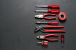 © Alvaro - Tools organized neatly on a dark surface in a workshop setting for repair tasks