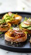 © lanters_fla - Varied appetizers on toasted bread topped with fresh vegetables and garnishes