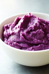 Poster - A close-up of a white bowl filled with creamy purple mashed potatoes, great for food and culinary related photoshoots