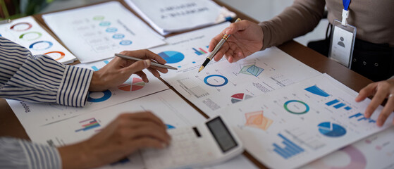 business team collaborating on financial analysis with charts and graphs during a strategy meeting