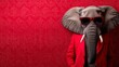 © Chineewan Somsap - stylish elephant wearing sunglasses and red suit against vibrant red background exudes charm and elegance