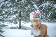 © Светлана  - Beautiful mother with her little daughter in her arms on a walk in the winter forest with a llama and an alpaca, surrounded by snow-covered pine trees