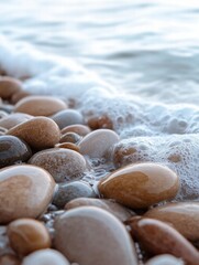 Leinwandbilder - Close up view of smooth beach pebbles with gentle waves washing over them at sunset on a tranquil shore. Generative AI