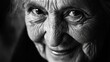© NfL - Close-up black and white portrait of a smiling elderly woman with deep wrinkles and expressive eyes.