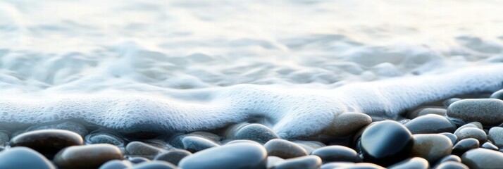 Poster - Close up view of smooth beach pebbles nestled along the shore with gentle waves lapping at their surfaces during sunset. Generative AI