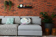 © New Africa - Modern living room interior. Comfortable sofa near brick wall