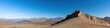 © Andrii Zastrozhnov - A mountain range with a blue sky in the background. The mountains are covered in snow and the sky is clear
