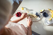 © Marko Geber - Senior woman preparing healthy breakfast with fresh fruits and avocado in modern kitchen