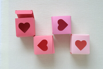 Wall Mural - scattered paper boxes with heart-shaped cutouts on a blank background