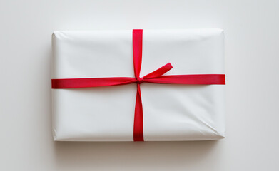 Sticker - Minimalist white gift box tied with a bright red ribbon bow on a clean white background.