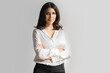 © Stock 4 You - Isolated portrait confident middle eastern businesswoman, business lady standing with crossed arms on grey background. Young Arabian or latin woman in formal clothes looking at camera, copy space