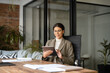 © Stock 4 You - Young latin Hispanic professional business woman working on pad pc computer. Middle eastern businesswoman holding digital tablet using tab application sitting at desk workplace in office. Copy space