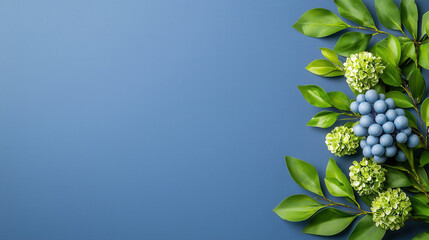 Leinwandbilder - vibrant arrangement of green leaves and blue berries on blue background, creating fresh and natural aesthetic. Perfect for nature themed designs