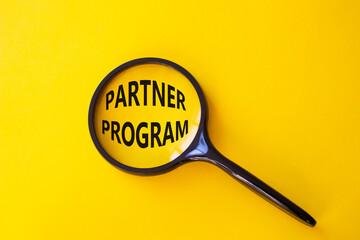 partner program symbol. concept words partner program on magnifying glass. beautiful yellow backgrou