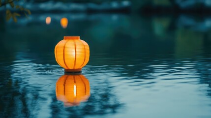 Leinwandbilder - Floating orange paper lantern reflected in calm water at dusk with soft lighting and serene atmosphere Copy Space