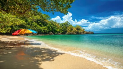 Poster - Tropical beach with colorful umbrella and calm turquoise waters under blue sky with white clouds Copy Space
