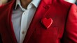 © Tobi - Stylish professional in a bold red suit showcasing a heart-shaped badge at a networking event
