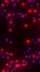 Leinwandbilder - Vertical video with neon red pink round particles spread across a black background
