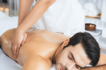 caucasian man customer enjoying relaxing anti-stress spa massage and pampering with beauty skin recr