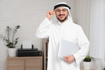 Wall Mural - Arab businessman with laptop in office