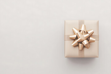 Top view of gold gift box with ribbon and bow isolated on a white background