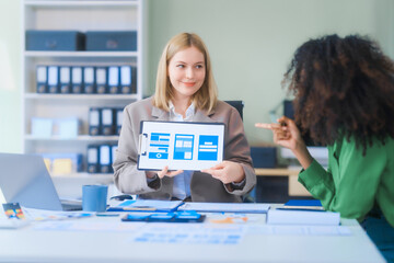 a young african american woman and a young russian woman work together in a business office. they di