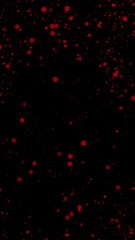 Aufkleber - Bright red confetti-like particles spread across a black background in an abstract pattern, Vertical video animation 

