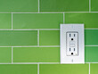 © davidrh - A GFCI (Ground Fault Circuit Interrupter) electrical outlet on a green tiled wall