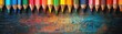 © Creative_Bringer - Row of sharpened colored pencils against a wooden backdrop, bright and colorful, aligned perfectly