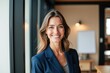 © SimpleDesignStudio - Confident Businesswoman in Professional Setting Showcasing Leadership Skills and Modern Work Environment with Natural Light