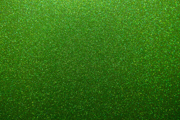 Full frame macro abstract texture background of a sparkling green color glitter surface
