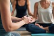 © SimpleDesignStudio - Tranquil Group Meditation Session with Focused Individuals Practicing Mindfulness and Inner Peace in a Calm Yoga Studio Environment