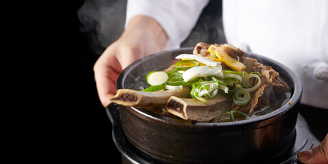 Wall Mural - Galbitang in the hands of a chef, traditional Korean food