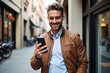 © SimpleDesignStudio - Smiling Man in Brown Leather Jacket Using Smartphone on City Street: Urban Lifestyle and Modern Technology Blend in Everyday Moments