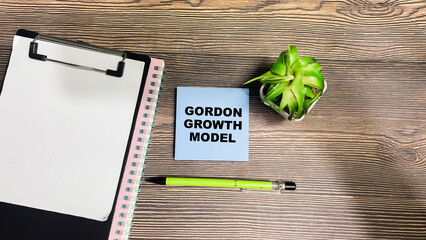 Wall Mural - Concept of Gordon Growth Model write on sticky notes isolated on Wooden Table.